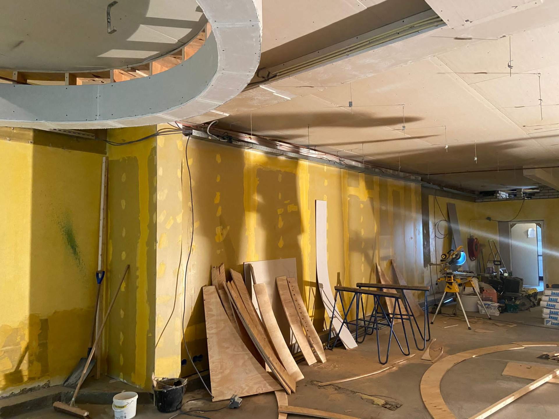Casco fase — wandopbouw met geel afgesmeerd stucwerk en plafondprofielen